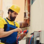 Precise repairman contracted by client to detect air conditioner issues, tracking nitrogen pressure loss and adjusting superheat and subcooling level values measured by ac gauges vacuum pump